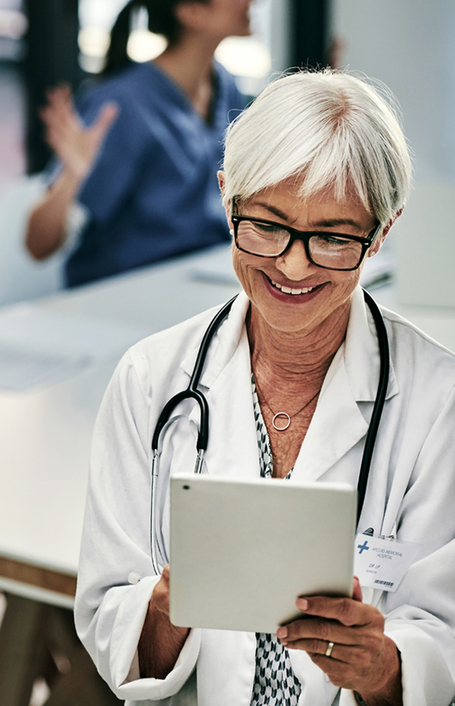 Medical personnel holding a tablet